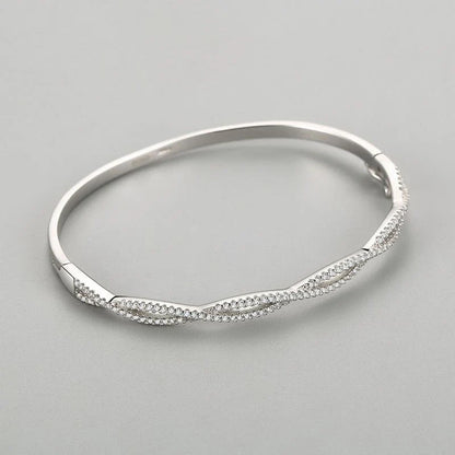 Elegant silver bracelet with a captivating wave-like design, a premium micro-set jewelry piece crafted with superior Seiko technology
