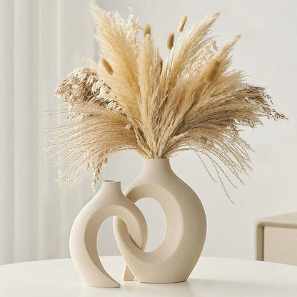 A set of two modern, minimalist white ceramic vases with a textured finish, designed to elevate any home decor.