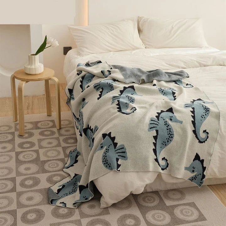 Cozy cotton blanket with cute sea horse design, perfect for relaxation and comfort