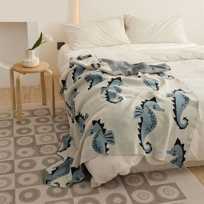 Cozy cotton blanket with cute sea horse design, perfect for relaxation and comfort