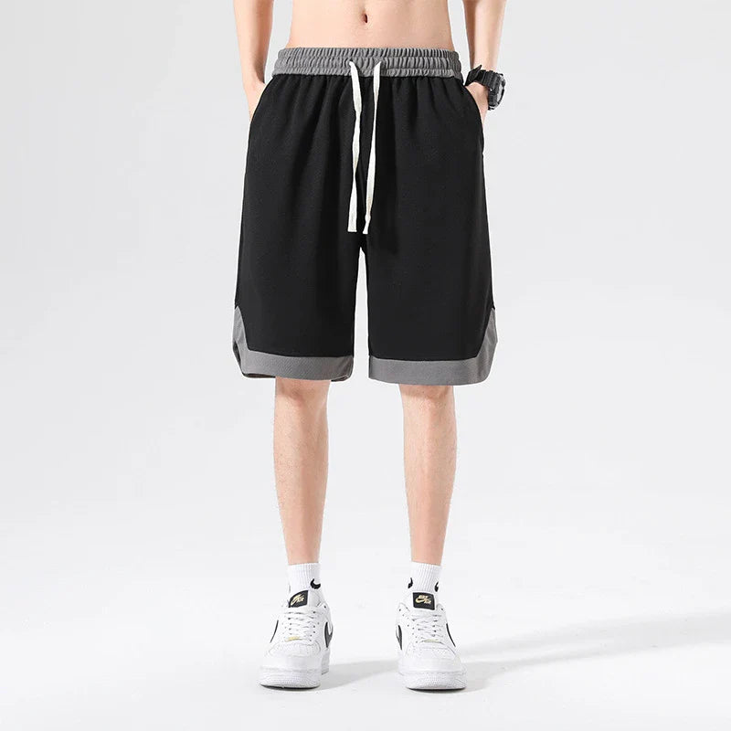 Men's loose and comfortable sports pirate shorts in white, gray, and black colors with elasticized waistband and relaxed fit