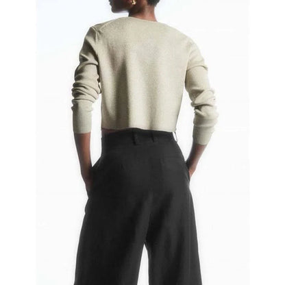 A cozy and chic v-neck cardigan in a classic solid color, featuring a slim, flattering fit and elegant button detailing for versatile autumn and winter wear.