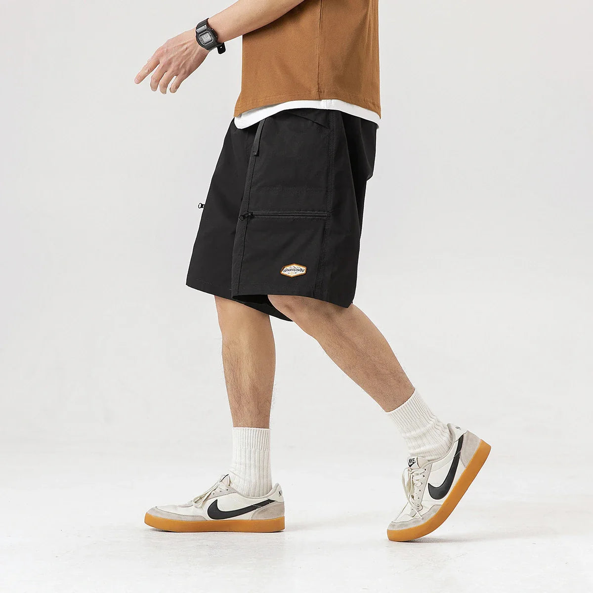 Mountain Vintage Workwear Shorts in black, orange, and army green colors, featuring a fifth-length design and convenient pockets for versatile functionality.