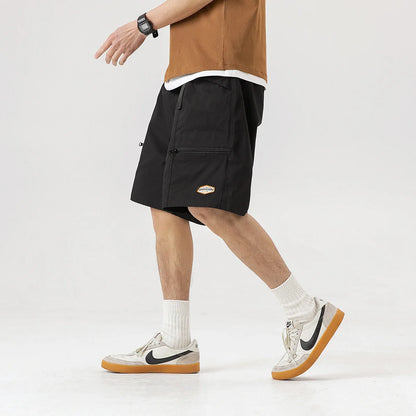 Mountain Vintage Workwear Shorts in black, orange, and army green colors, featuring a fifth-length design and convenient pockets for versatile functionality.