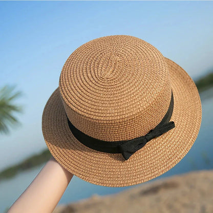 Classic straw Panama hat with a bow detail, offering sun protection and fashionable summer style