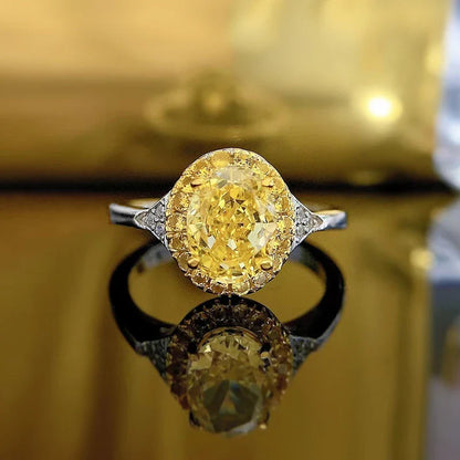Elegant yellow diamond cocktail ring with a sleek, silver-toned band and a regal crown-shaped setting