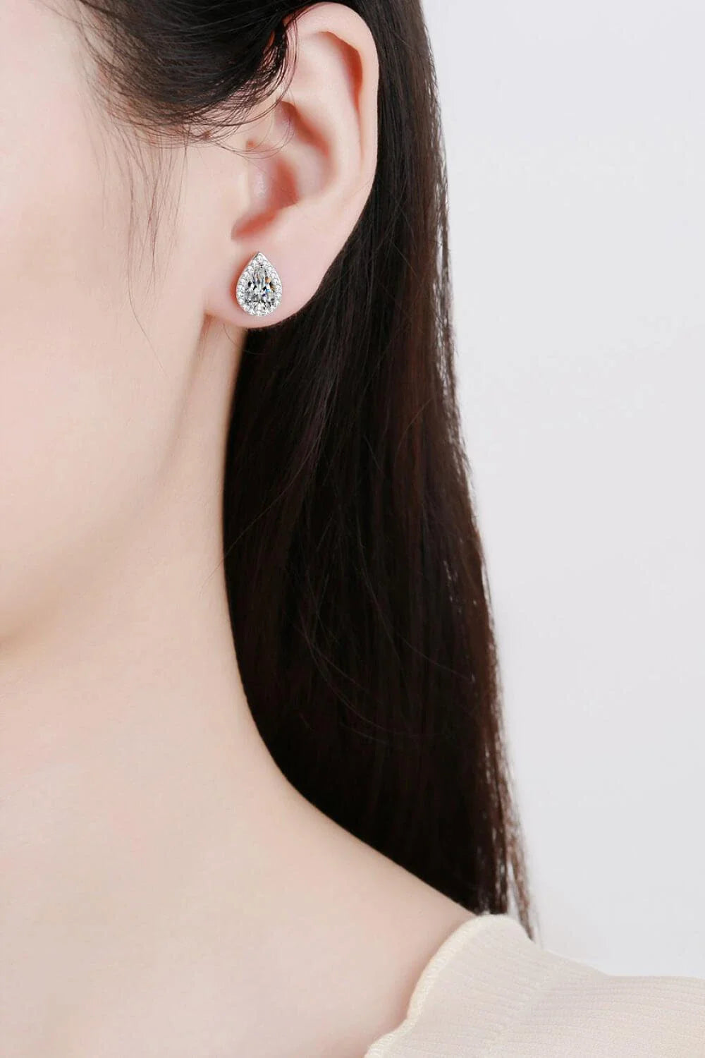Captivating 925 sterling silver moissanite teardrop stud earrings with a polished rhodium-plated finish and zircon accent stones
