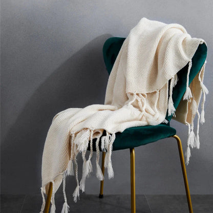Luxurious Nordic wool knitted throw blanket with tassels in a solid gray color, a cozy and elegant home decor accessory