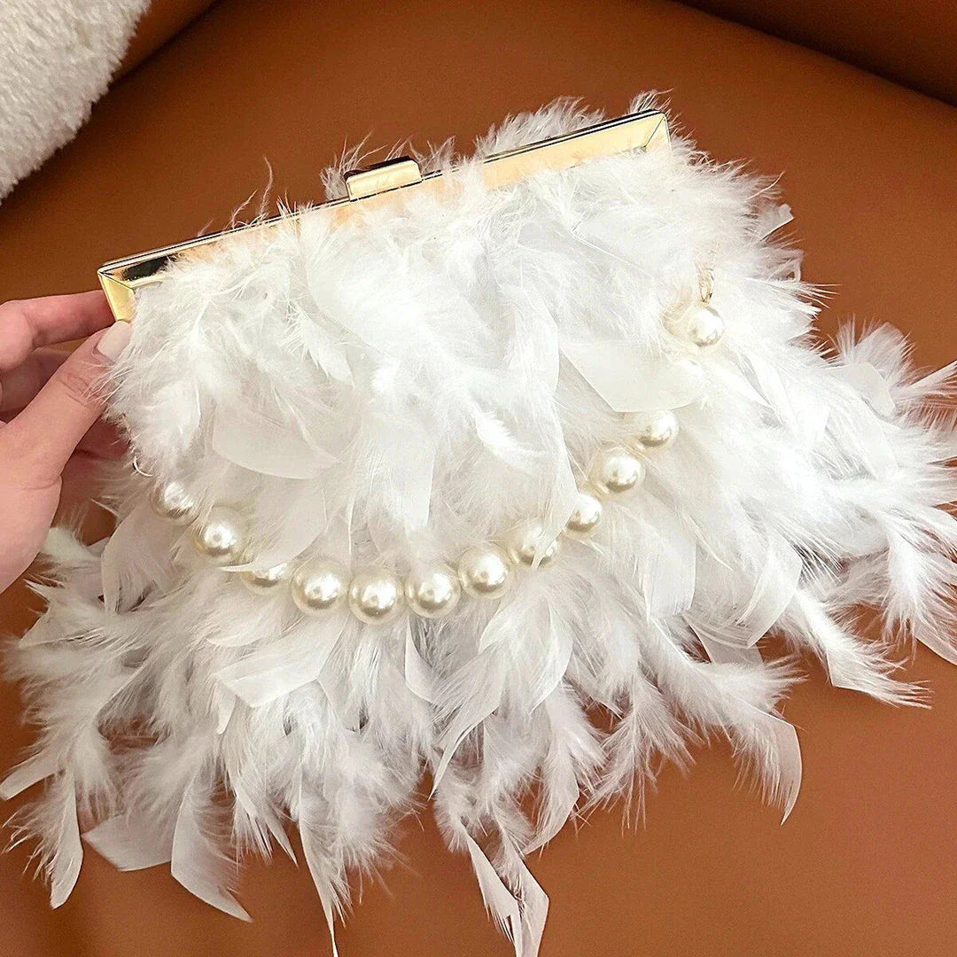 Elegant feather clutch bag with pearl embellishments and metal chain details
