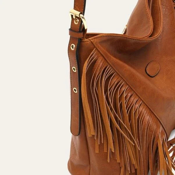 Chic vegan leather shoulder bag with tassel decoration, featuring a spacious interior and versatile carrying options