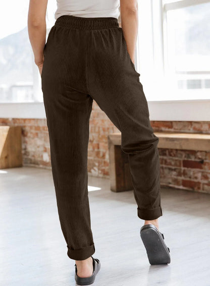 A pair of stylish corduroy pants for women with a wide-leg silhouette, elastic waistband, and side pockets.
