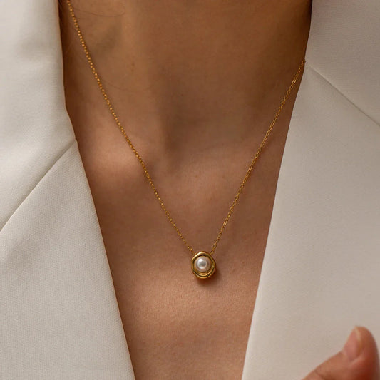 Elegant stainless steel pearl pendant necklace with a geometric design, perfect for women's fashion and everyday style.