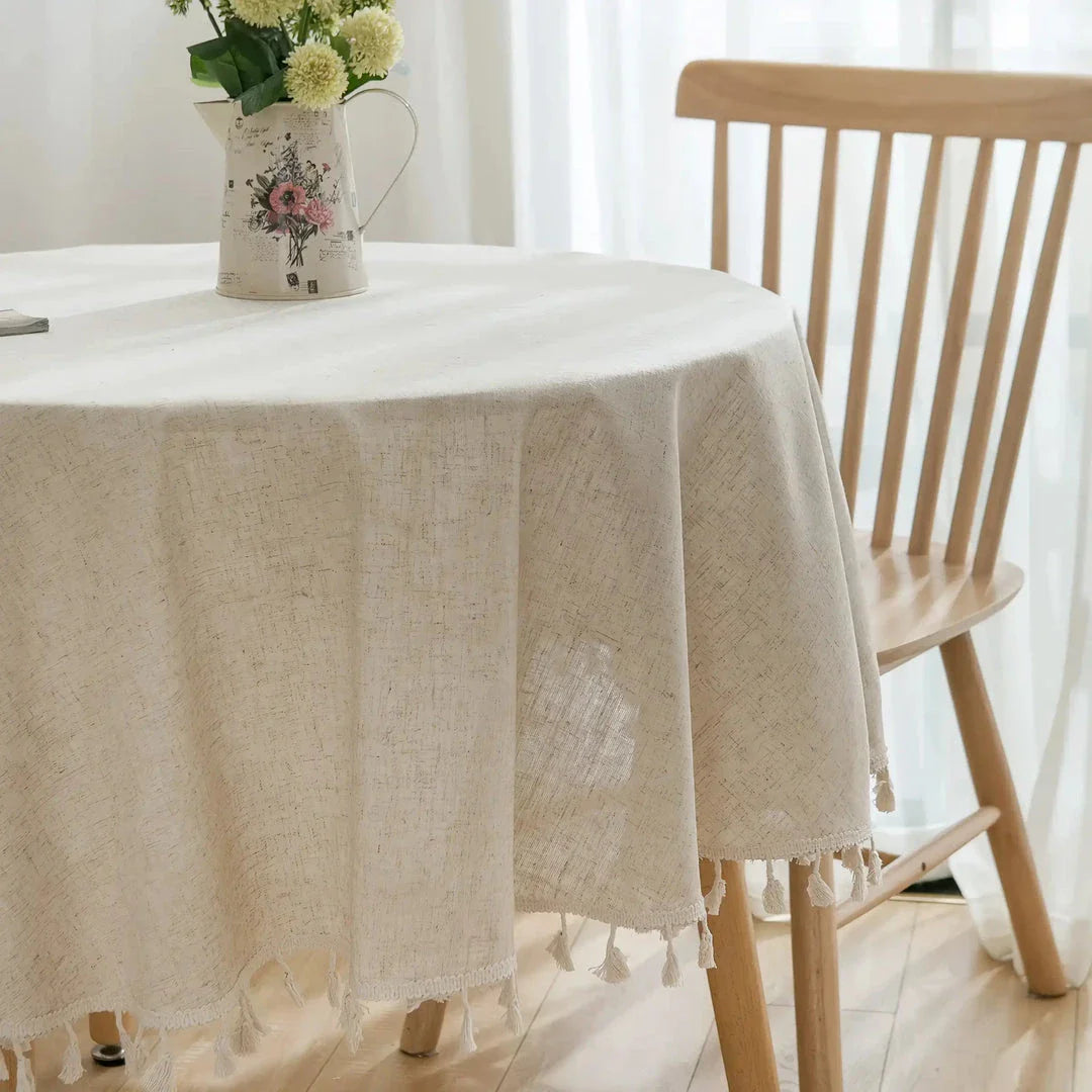 Sophisticated cotton-linen blend round tablecloth with elegant tassels, available in multiple sizes for versatile dining settings