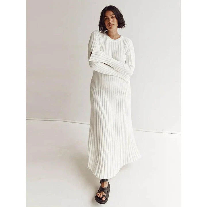 Timeless elegant pleated knit dress in black, perfect for summer office wear with a sophisticated and comfortable design.