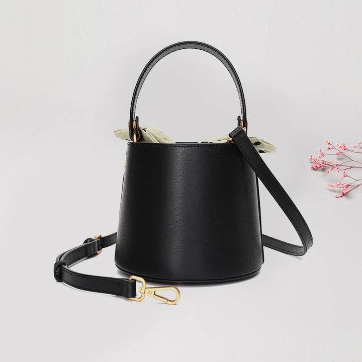 Premium leather bucket bag tote with bow-type closure, exquisite golden hardware, and versatile design