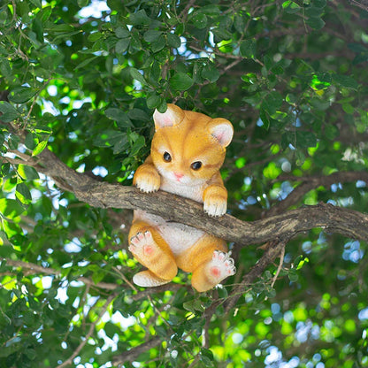 Charming resin cat statue with lifelike details, climbing on a tree branch and adding whimsical flair to any garden or indoor space.
