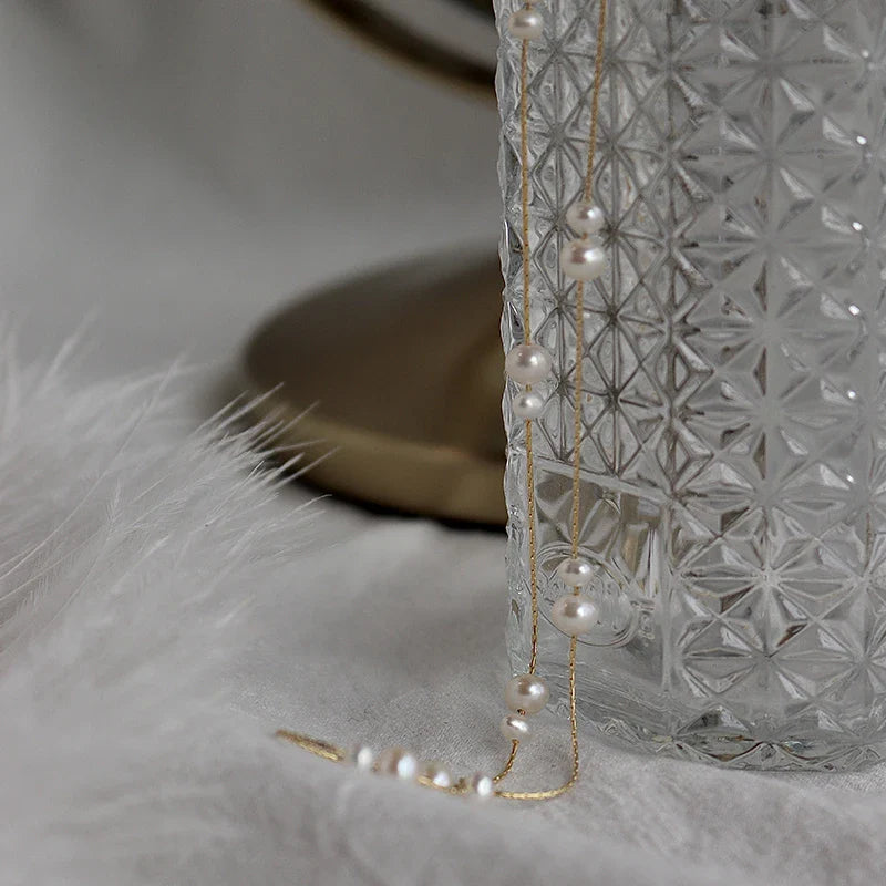 Elegant mother-of-pearl necklace with delicate butterfly and dragonfly motifs, inspired by Asian design