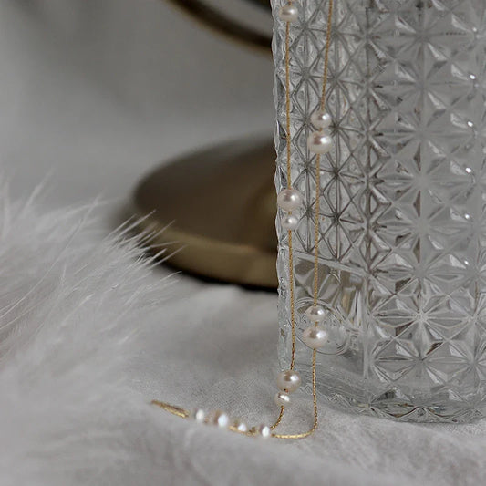 Elegant mother-of-pearl necklace with delicate butterfly and dragonfly motifs, inspired by Asian design