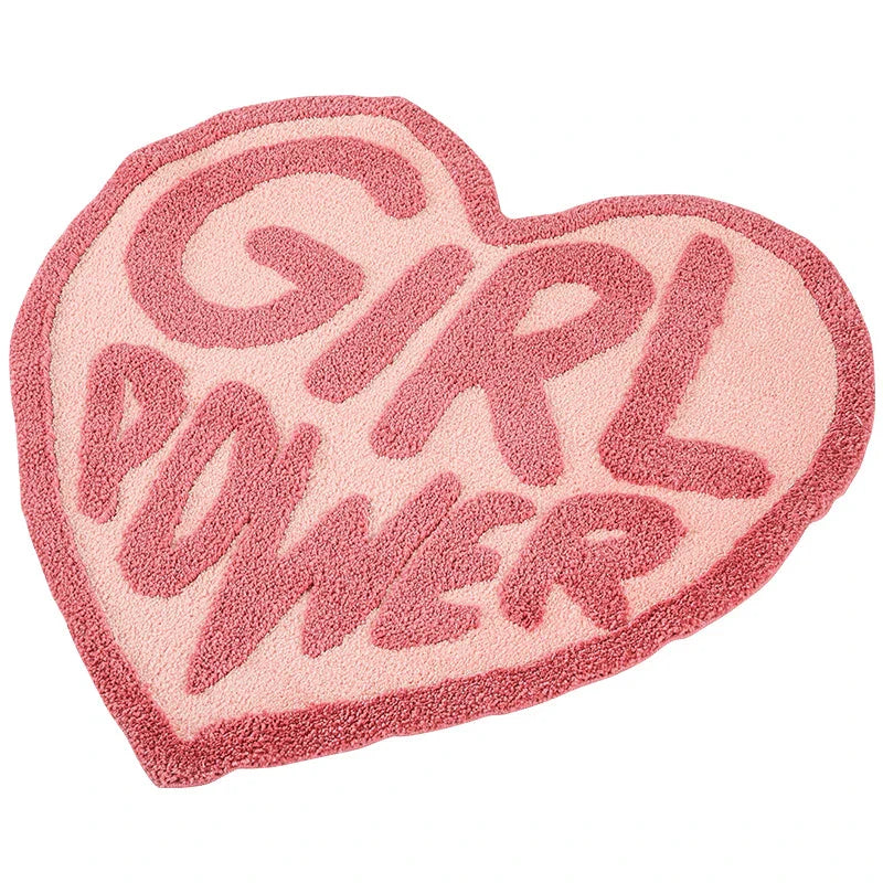 Cozy pink heart-shaped tufted rug with 'GRL PWR' message, perfect for girls' rooms, dressing rooms, and bathrooms