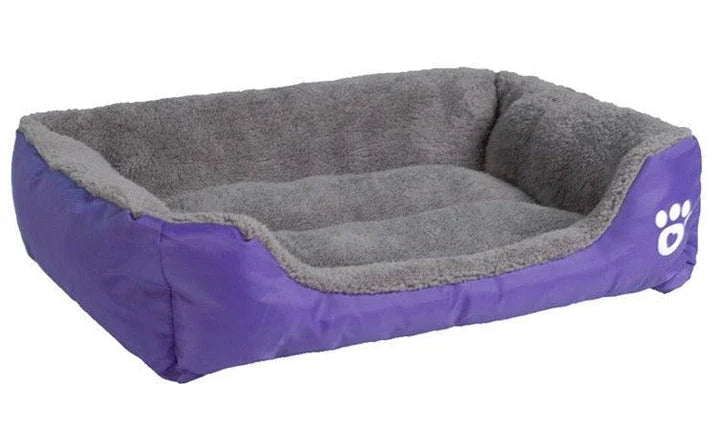A plush, green pet bed with a paw-print pattern, designed to provide cozy and waterproof comfort for pets.