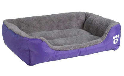 A plush, green pet bed with a paw-print pattern, designed to provide cozy and waterproof comfort for pets.