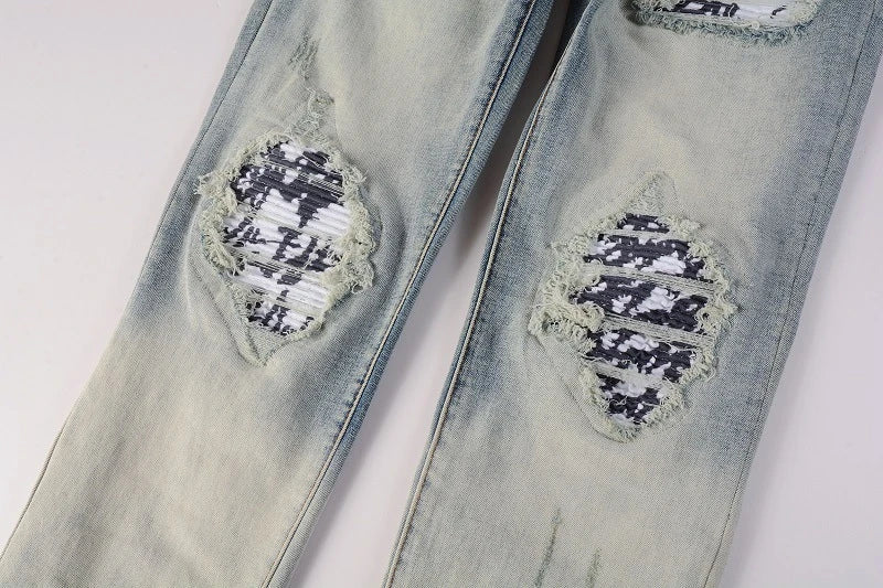 American High Street fashionable men's ripped black and white patch jeans in a light blue denim color