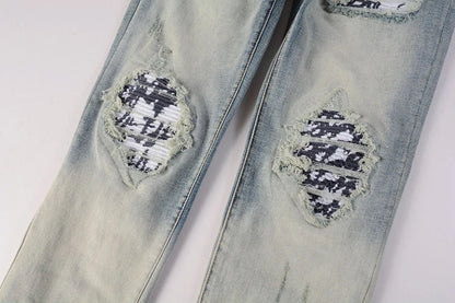American High Street fashionable men's ripped black and white patch jeans in a light blue denim color