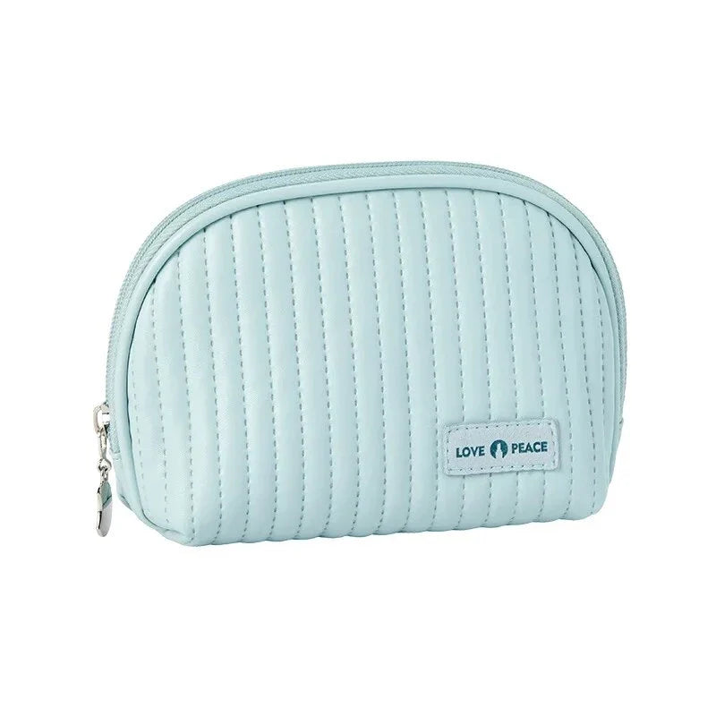 Stylish compact makeup bag made of premium PU leather in light blue color, with a sleek minimalist design for modern women