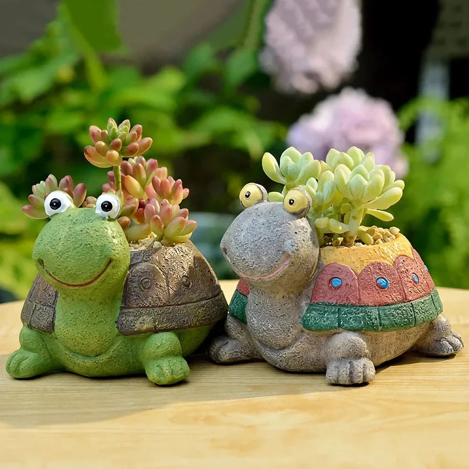 Charming gray cartoon turtle planter holding small potted succulents and cacti