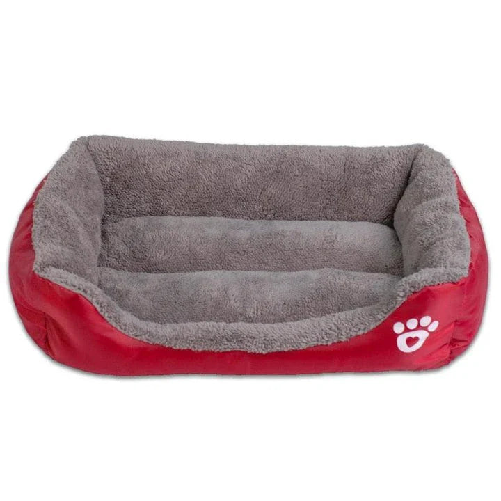 A plush, green pet bed with a paw-print pattern, designed to provide cozy and waterproof comfort for pets.