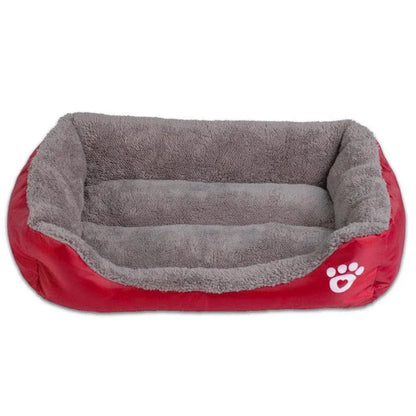 A plush, green pet bed with a paw-print pattern, designed to provide cozy and waterproof comfort for pets.
