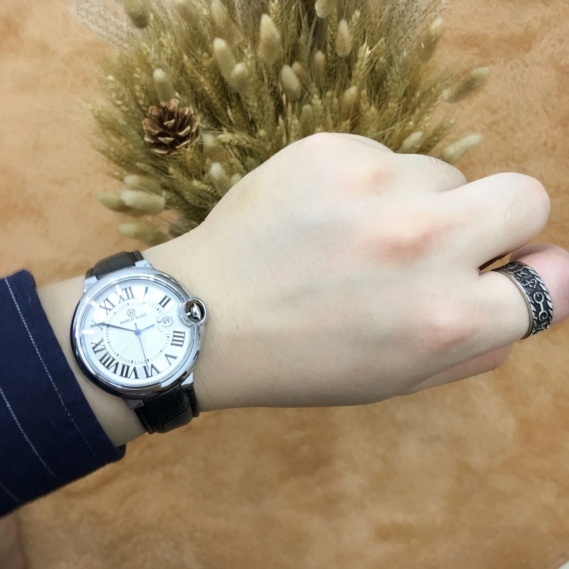 Stainless steel men's watch with large dial, calendar function, and adjustable band