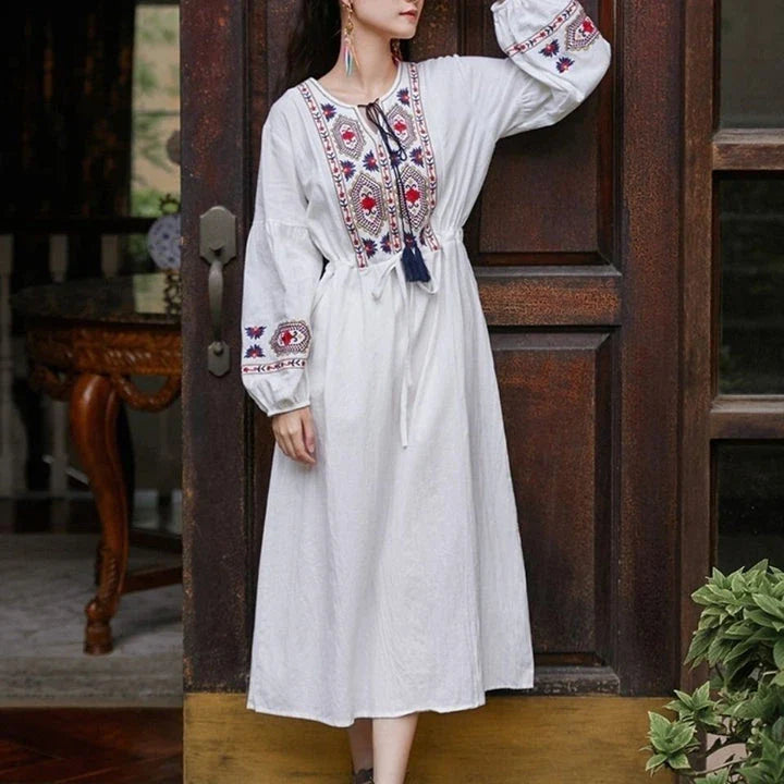 Elegant embroidered cotton-linen dress with tassels, featuring a waist-cinching A-line silhouette in vibrant colors