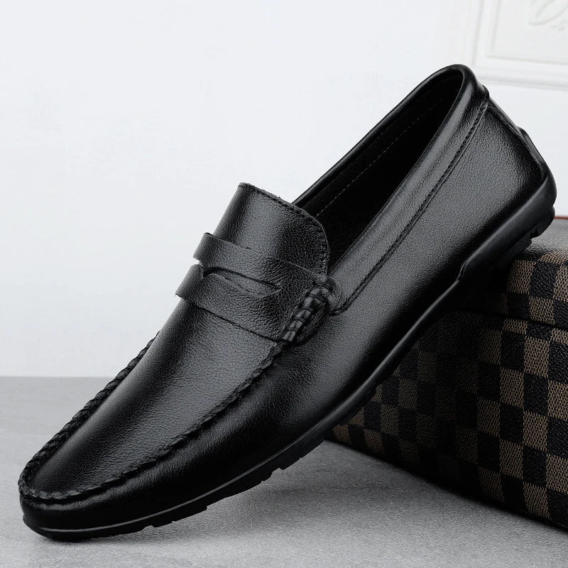 Men's driving shoes in black cowhide leather with sleek, round-toe design for superior driving control and style