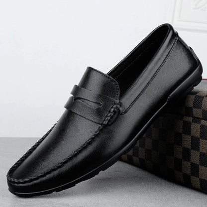 Men's driving shoes in black cowhide leather with sleek, round-toe design for superior driving control and style