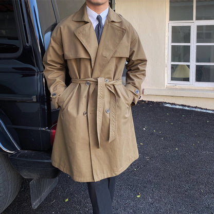 Commuter-friendly mid-length trench coat with double-breasted lapels, made from durable cotton-polyester blend fabric