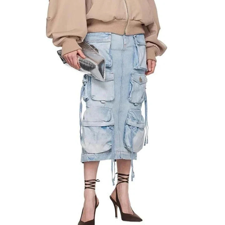 A high-waisted denim skirt with a distressed ribbon slit, perfect for adding a touch of fashionable flair to your spring wardrobe.