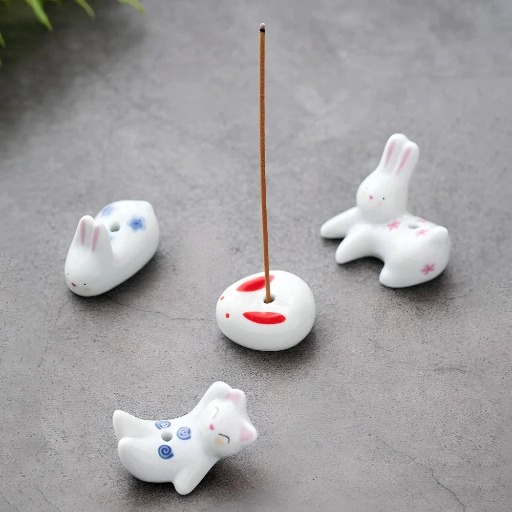 Charming ceramic incense holder featuring a cute rabbit and kitten design, perfect for adding a touch of whimsy and tranquility to any room.