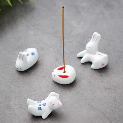 Charming ceramic incense holder featuring a cute rabbit and kitten design, perfect for adding a touch of whimsy and tranquility to any room.