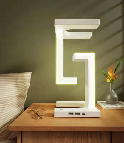 A modern, levitating desk lamp with wireless charging capabilities for smartphones
