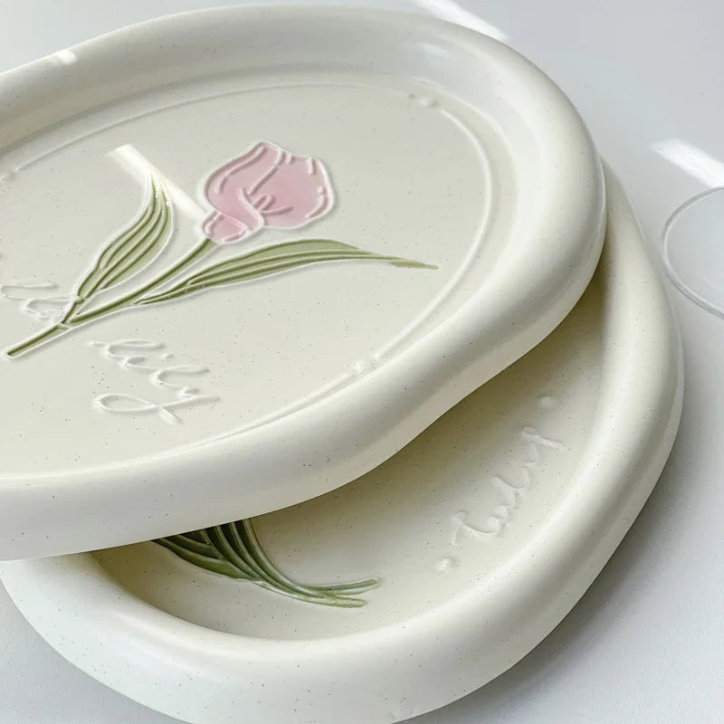 Elegant ceramic plate featuring a delicate floral relief design of Calla Lily and Tulip flowers, perfect for refined dining