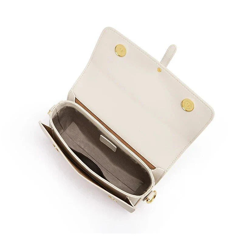 Elegant white leather crossbody bag for women with adjustable strap and multiple interior pockets for organized storage.