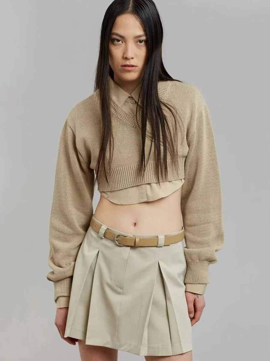 A cozy, knitted pullover sweater with a timeless round neck design, available in a versatile camel color.