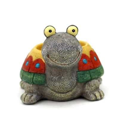 Charming gray cartoon turtle planter holding small potted succulents and cacti