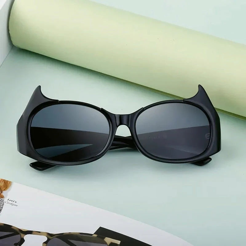 Stylish cat-eye sunglasses with oversized frames, semi-rimless design, and punk-inspired detailing for a timeless, glamorous look