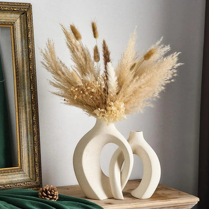 A set of two modern, minimalist white ceramic vases with a textured finish, designed to elevate any home decor.