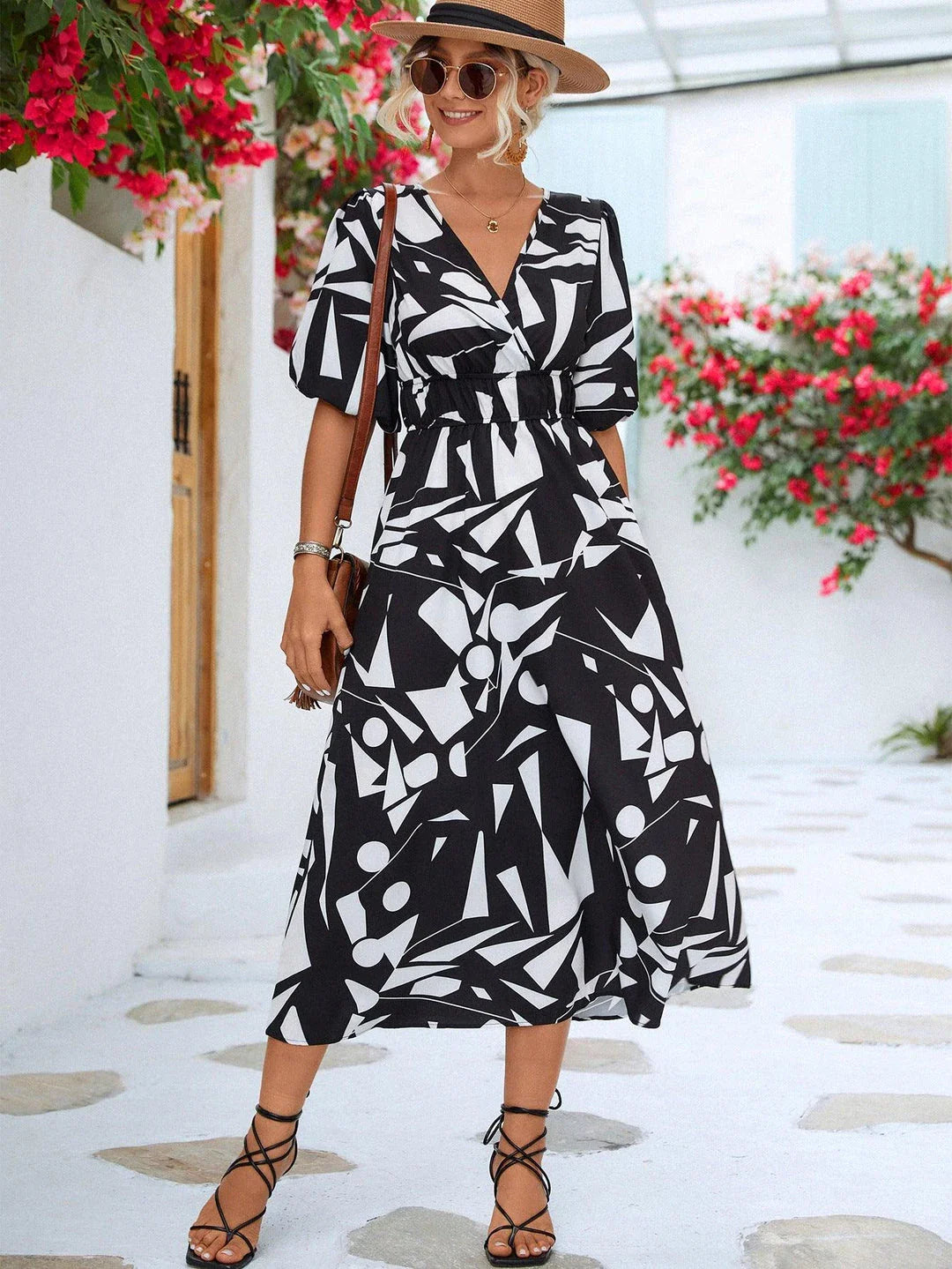 A stylish printed surplice dress with balloon sleeves, perfect for effortless elegance