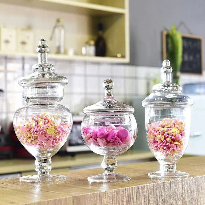 A transparent glass candy jar with an airtight lid, suitable for weddings, parties, and home decor