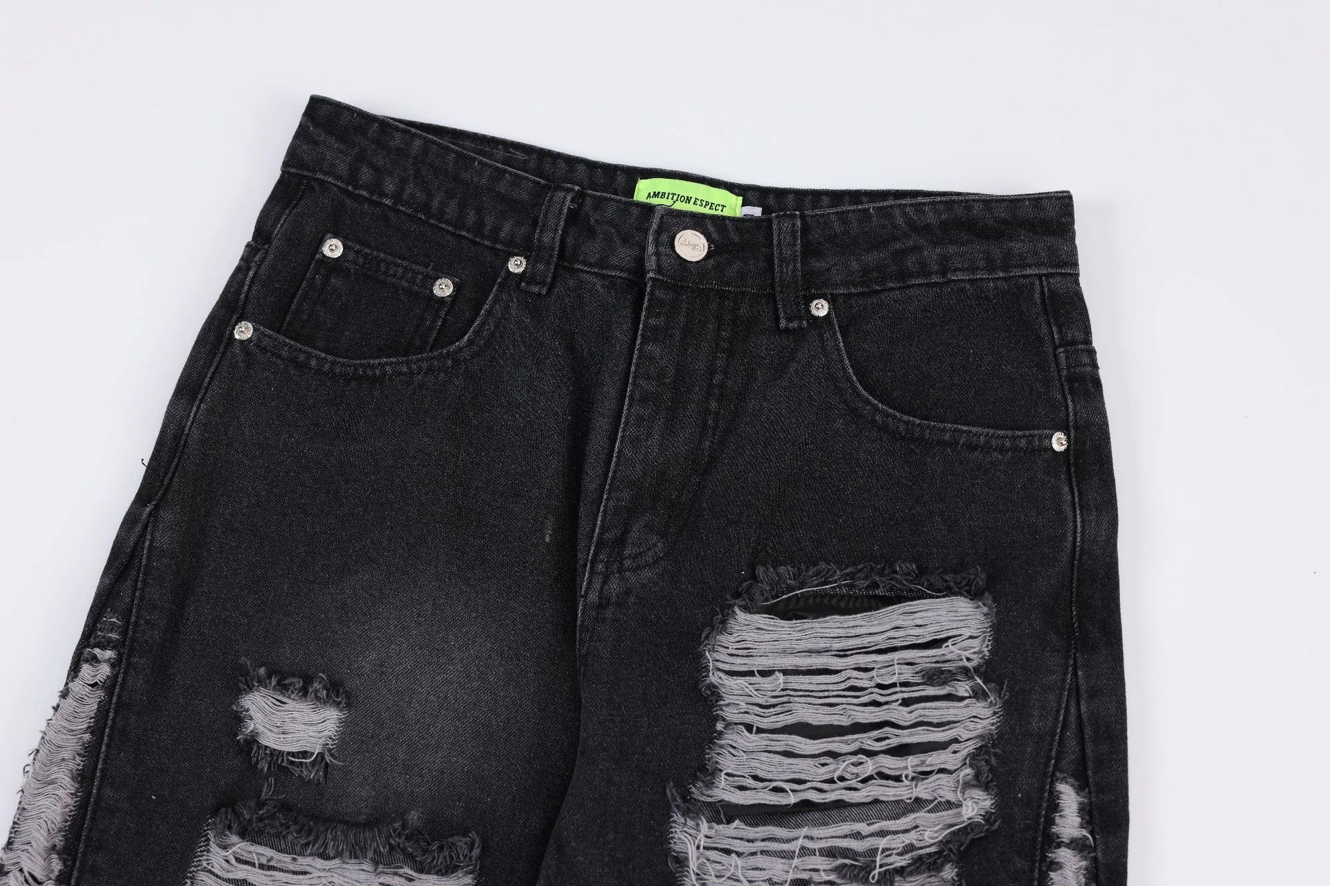 Premium loose fit distressed denim trousers for men and women, featuring a relaxed silhouette, high-quality cotton construction, and trendy distressed details.