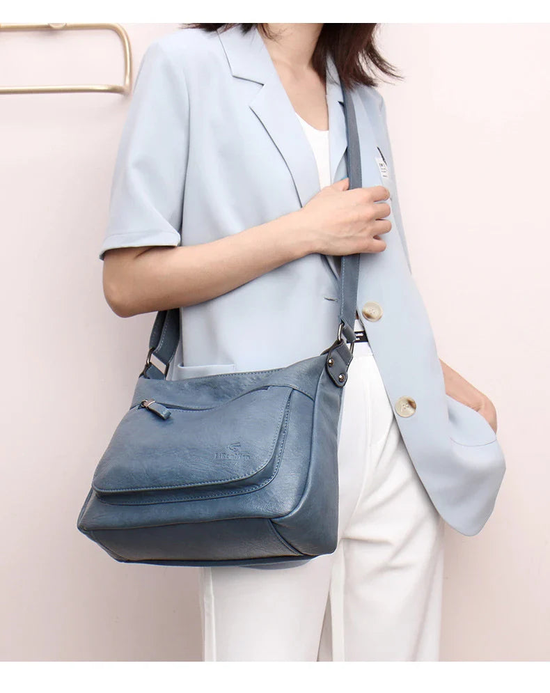 Stylish one-shoulder messenger bag in various colors with a soft, supple PU leather exterior and a spacious, organized main compartment
